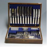 A mid-20th century oak cased canteen of silver plated cutlery (incomplete six place setting)