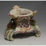 A 19th century Meissen porcelain table centrepiece, having floral encrusted and gilt C-scroll