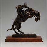 A Franklin Mint bronze figure 'The Bronco Buster', an official issue of The Frederick Remington