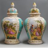 A pair of late 19th century Dresden porcelain vases and covers, each panel decorated with