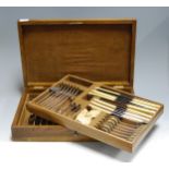 A mid-20th century oak cased canteen of silver plated cutlery (incomplete six place setting)