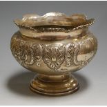 An Edwardian silver rose bowl having repousse floral and C scroll decoration with vacant cartouche