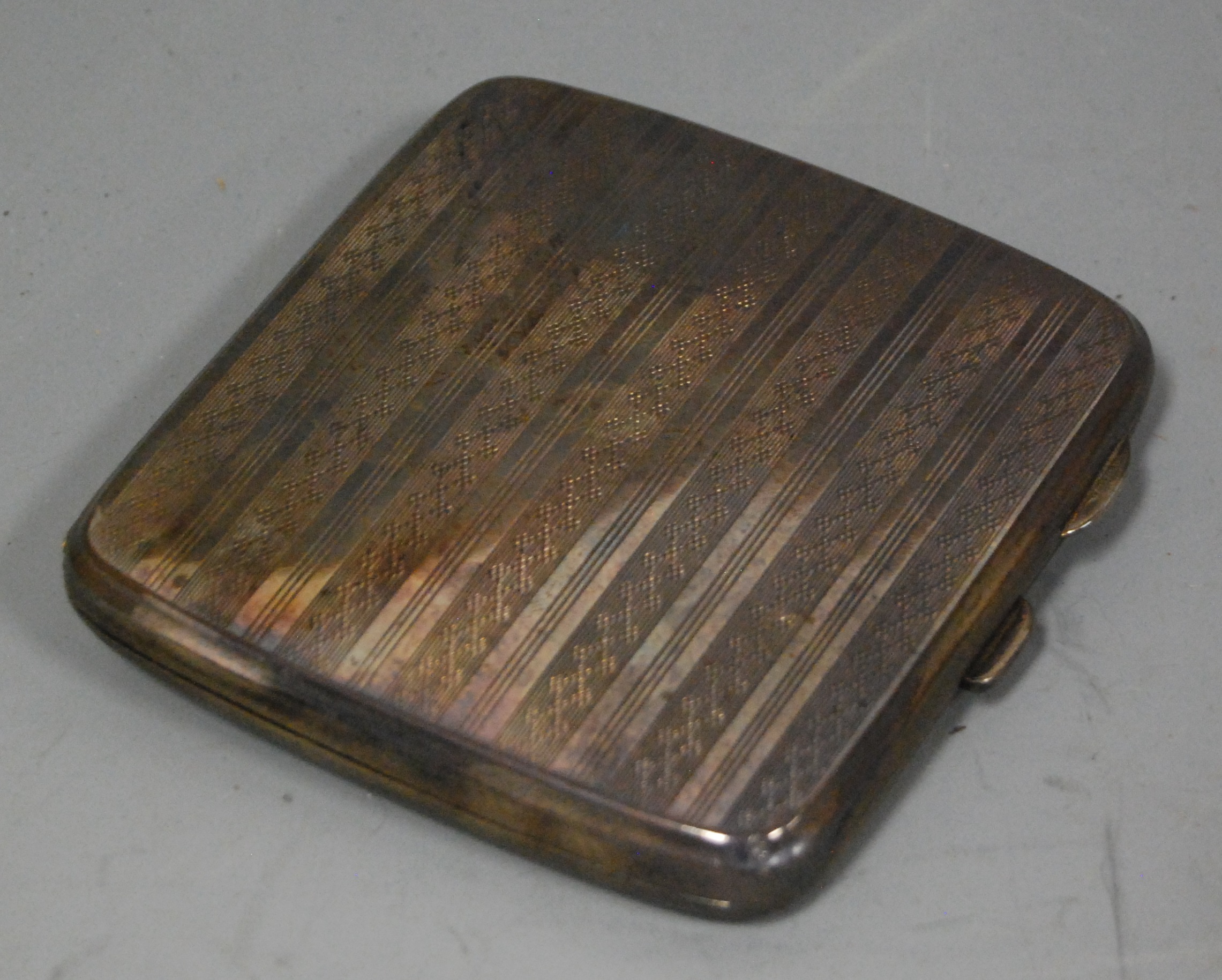 A George V silver pocket cigarette case, having all-over engine turned decoration and gilt interior