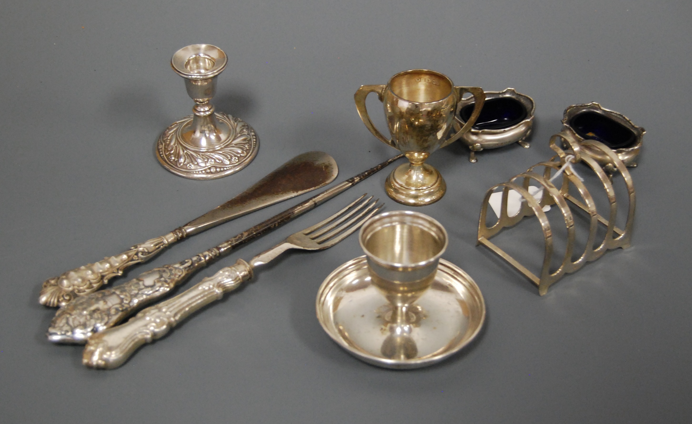 A collection of miscellaneous silver items to include a pair of George V open salts with blue