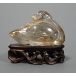 A Chinese quartz carving of a bird on pierced hardwood base