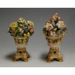 A pair of early 19th century Derby porcelain floral encrusted garniture urns, on gilt heightened