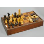 A Victorian rosewood and boxwood travelling games board, together with turned boxwood and rosewood