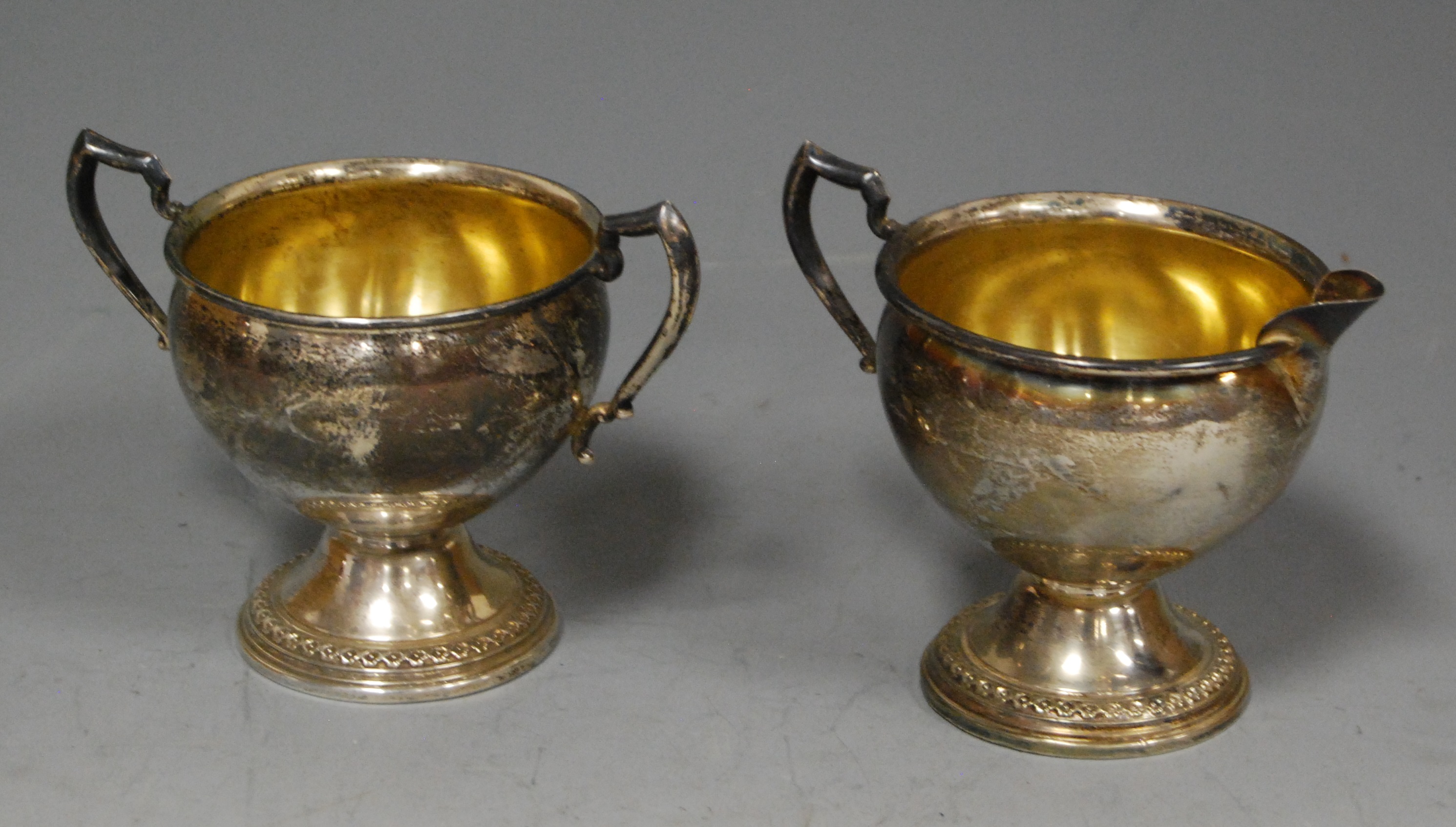 An early 20th century sterling silver cream jug, of plain undecorated form, having gilt washed