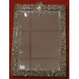 A late Victorian silver and velvet clad wall mirror, the rectangular bevelled plate within a