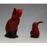 A Royal Doulton flambé figure of a cat, in seated pose, h.13cm; together with a Royal Doulton flambé