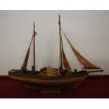 A scratch built model of a sailing boat with full masts and rigging