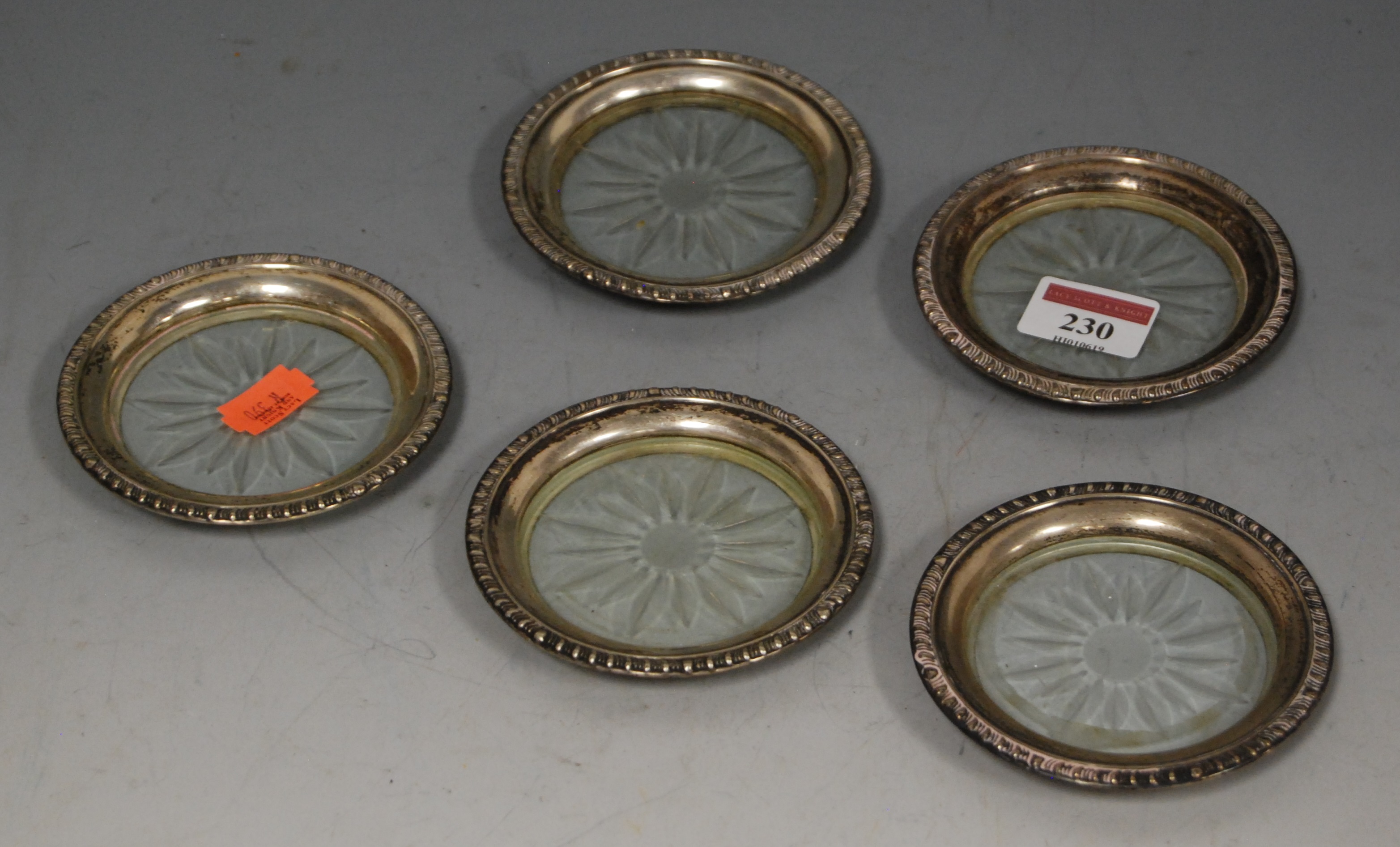 A set of five early 20th century sterling silver mounted and cut glass table coasters