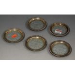 A set of five early 20th century sterling silver mounted and cut glass table coasters