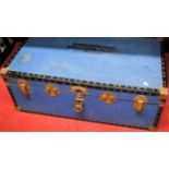 A canvas bound trunk with gilt metal fittings