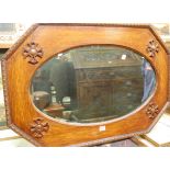 An early 20th century moulded oak octagonal wall mirror, with bevelled oval plate, w.85cm