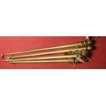 Four lacquered brass curtain poles with turned finials and rings, the largest approx 172cm