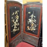 An early 20th century Japanese floral relief carved framed two division dressing screen, each