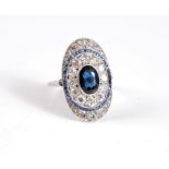 An early 20th century oval sapphire and diamond ring, the oval plaque set with a central collet