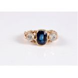 A late 19th century sapphire and diamond ring, the central oval sapphire, approx. 8.8 x 6.8 x 3.2mm,