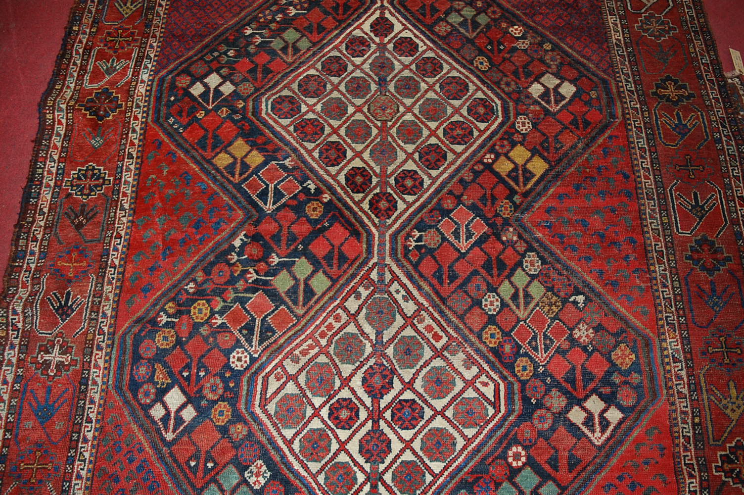 A late 19th century Persian woollen Luri rug, the rust coloured field decorated with three linked - Image 5 of 7