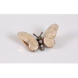 A 15ct gemset and diamond white butterfly brooch, with fossilised coral wings, collet set with