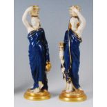 A pair of Royal Worcester figurines of water-carriers, each as robed maidens, polychrome decorated