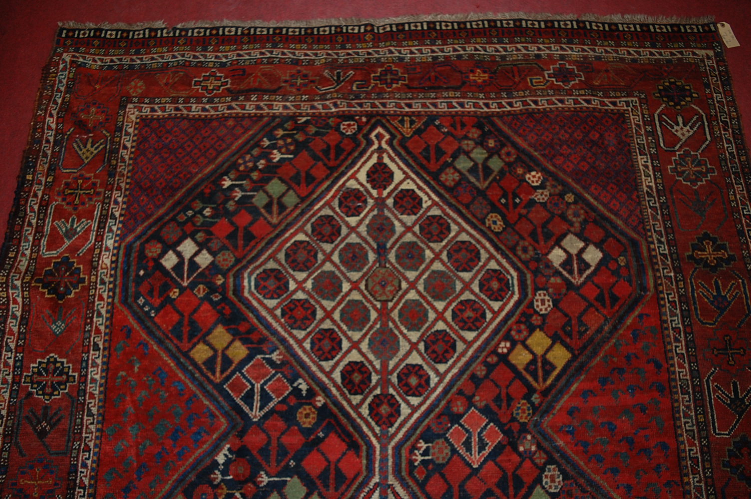 A late 19th century Persian woollen Luri rug, the rust coloured field decorated with three linked - Image 6 of 7