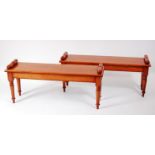 A pair of Victorian style oak window seats, each having a rectangular top with rolled ends, on