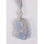 A Chinese carved chalcedony pendant, the rectangular carved pendant of two lotus fruits and a