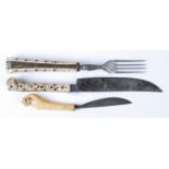 An 18th century North European ivory handled and steel knife and fork, the handles with brass and