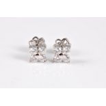 A pair of diamond earstuds, each comprised of four round brilliant cut diamonds, overall total
