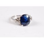 An 18ct sapphire and diamond ring, the old cushion cut sapphire, approx. 11.6 x 9.5 x 5.3mm, in