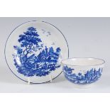 A Worcester porcelain blue and white tea bowl and saucer, printed in the European Landscape Group