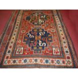 A circa 1900 Persian woollen rug, the red ground decorated in the cloud band design within