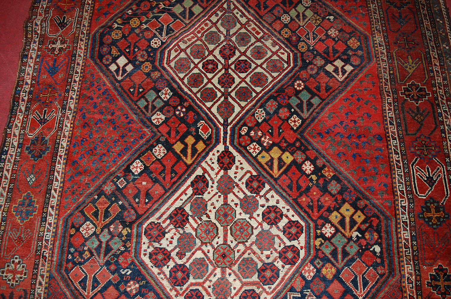 A late 19th century Persian woollen Luri rug, the rust coloured field decorated with three linked - Image 4 of 7