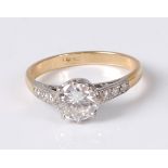 An 18ct gold and platinum faced diamond solitaire ring, the claw set brilliant weighing approx 0.
