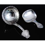 An early 20th century silver caddy spoon, having a deep bowl with wavy rim, the terminal with C-