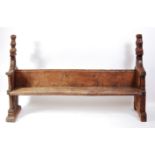 A medieval oak bench, circa 15th century, as de-accessioned from Elmswell Church, Bury St Edmunds,
