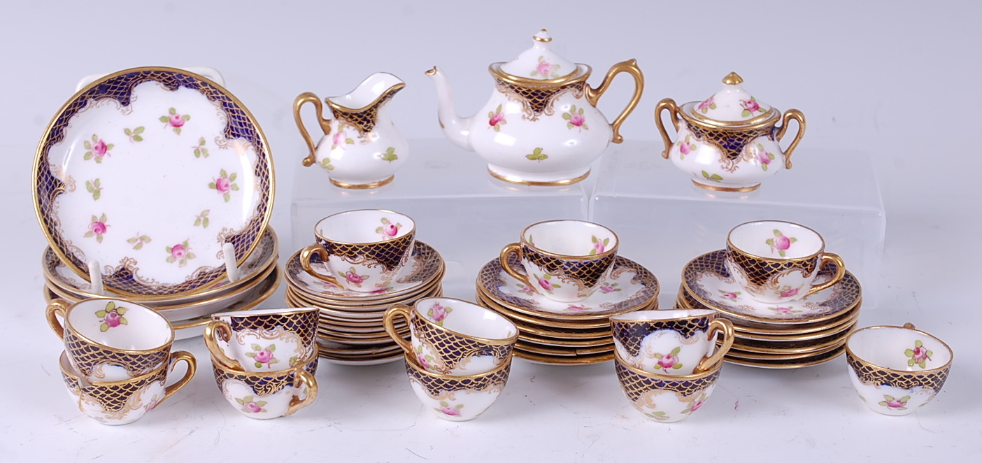 A Crown Staffordshire porcelain dolls part tea set, decorated in bright enamels with floral sprays