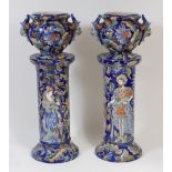 A pair of Continental majolica glazed pedestal jardinières, the blue ground all-over incised with