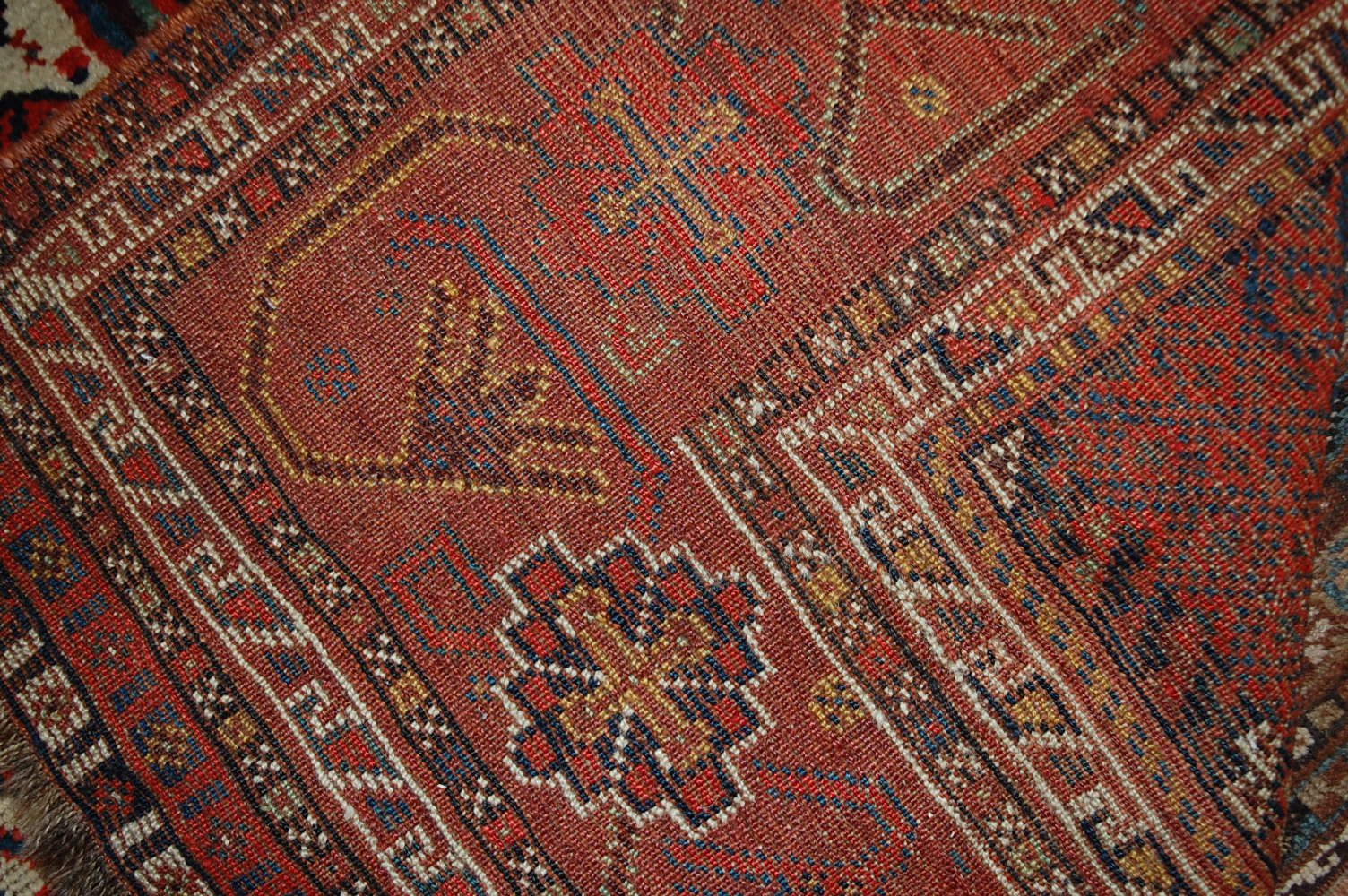 A late 19th century Persian woollen Luri rug, the rust coloured field decorated with three linked - Image 7 of 7