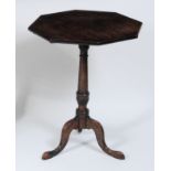 An early 19th century mahogany pedestal tripod table, having an octagonal boxwood strung tilt-top to