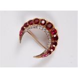 A ruby and diamond crescent brooch, the outer band of graduated mixed cut rubies, in rubover mounts,