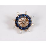 A sapphire, diamond and 'pearl' Captains wheel brooch, the central old cut diamond, estimated