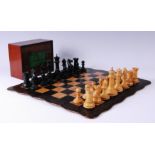 A 32 piece boxwood and ebony chess set , in original fitted box, one knight and rook of