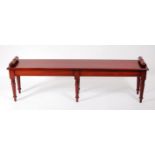 A large Victorian style mahogany window seat, having a rectangular top with rolled ends, raised on