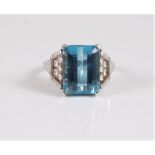 An aquamarine and diamond ring, the step cut aquamarine, approx. 12.1 x 9.2 x 6.8mm, in a four