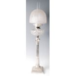 An Edwardian silver Corinthian column oil lamp, having diamond cut and engraved frosted glass shade,
