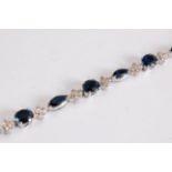An 18ct sapphire and diamond bracelet, the alternating oval and marquise shaped sapphires, each
