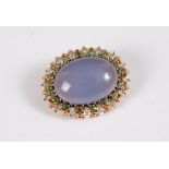 A chalcedony, diamond and emerald brooch, the oval chalcedony cabochon, approx. 22.8 x 16mm,